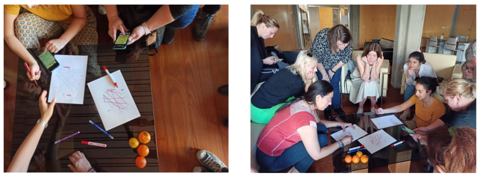 People sit around a table and draw with pens on paper.