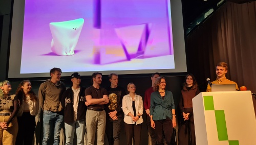 There are people standing on a stage. Behind them, there is a presentation showing an abstract 3D model of a dog.